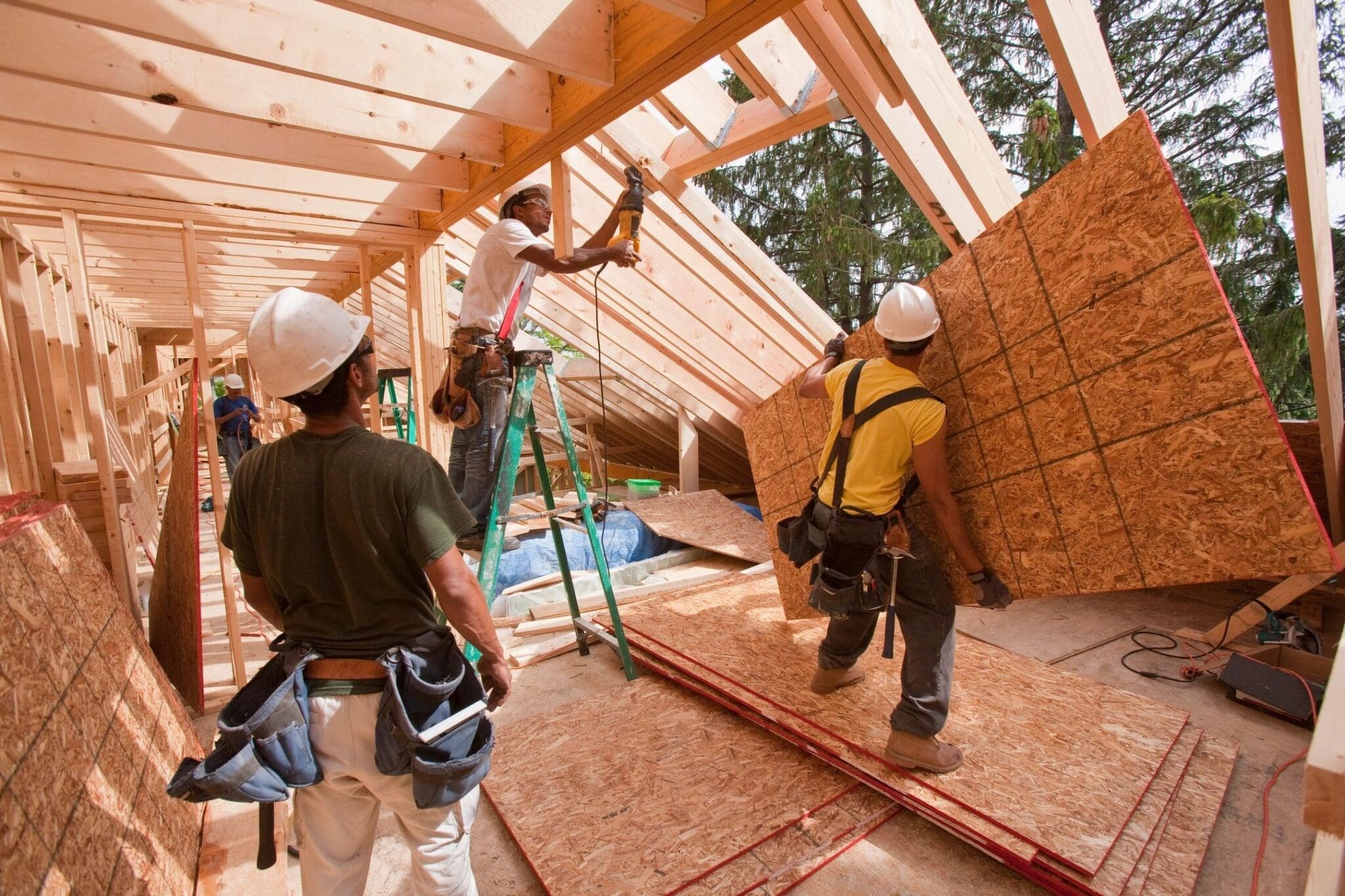 Construction workers building a wooden structure.