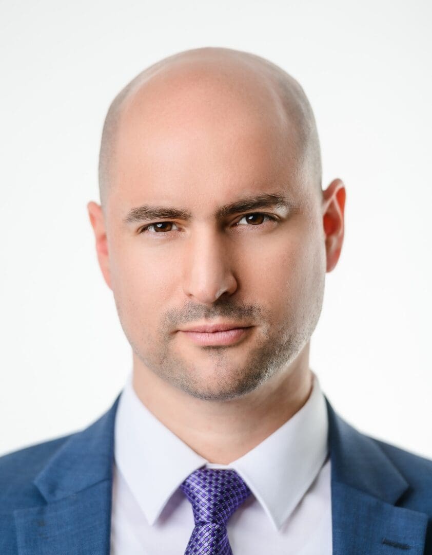 This is a photo of a man wearing a blue suit and tie.