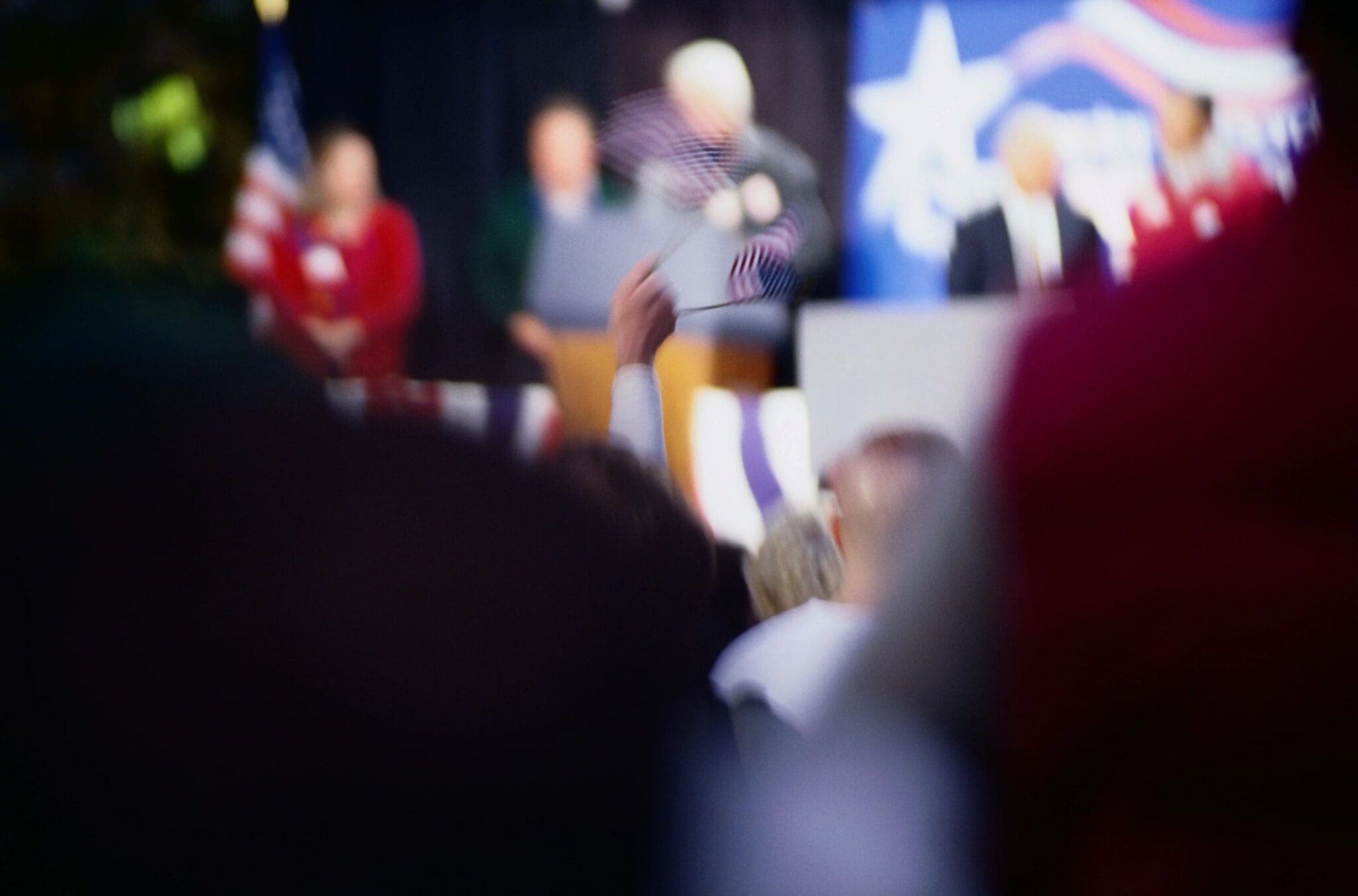 Blurry crowd at a patriotic event.