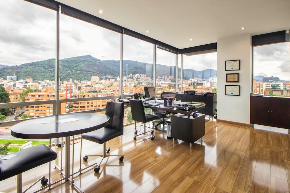 Modern office with city view and mountains.
