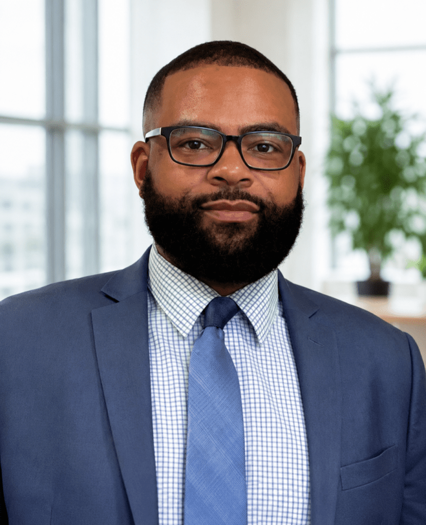 Bearded person in suit and tie, office