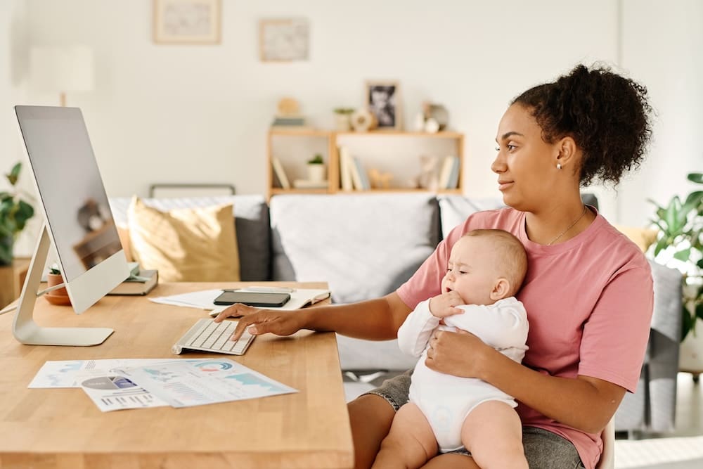 a woman holding her baby at home