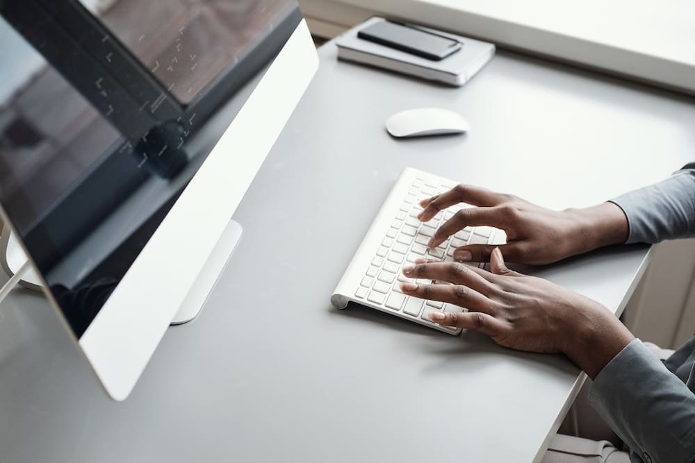 employee typing on the computer keyboard