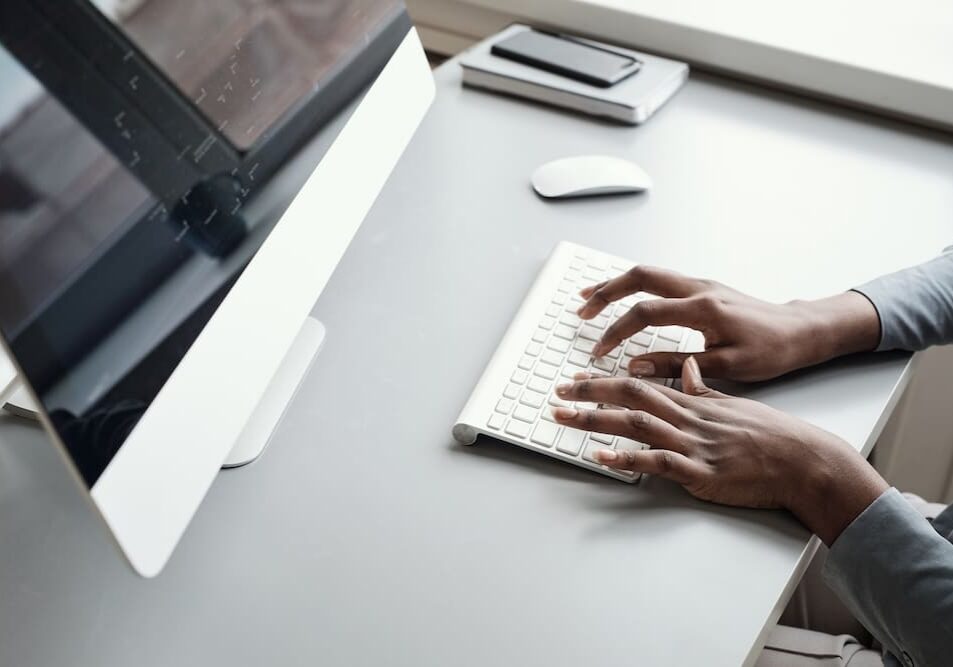 employee typing on the computer keyboard