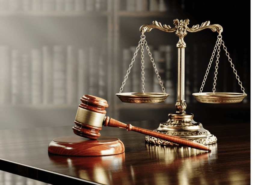 Gavel and scales of justice on table.