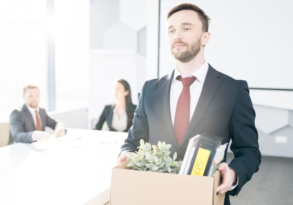 a man leaving an office with his belongings