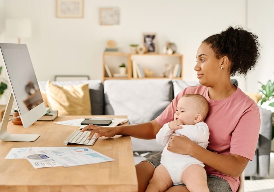a woman holding her baby at home