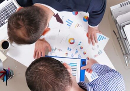 Business owners and counsel reviewing a business purchase agreement before signing