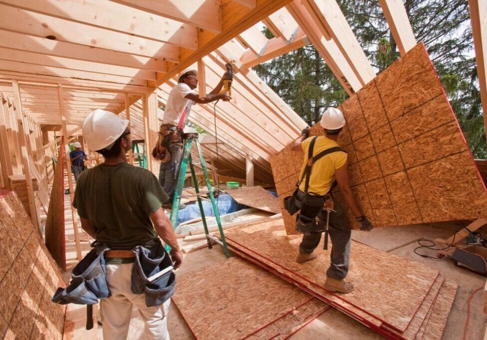 Construction workers building a wooden structure.