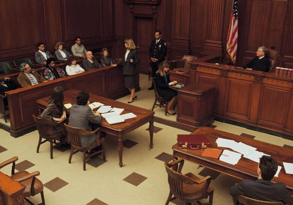 Courtroom scene with judge, jury, and lawyers.