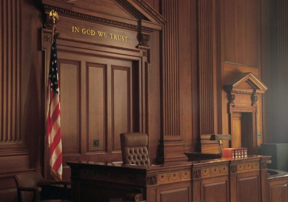 Courtroom interior with judge's bench and flag.
