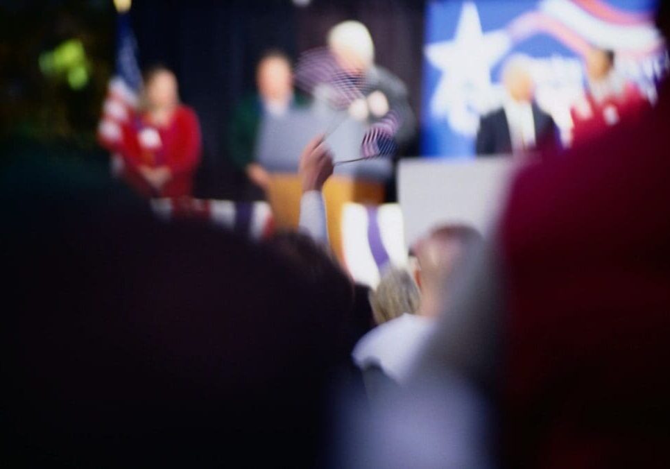 Blurry crowd at a patriotic event.